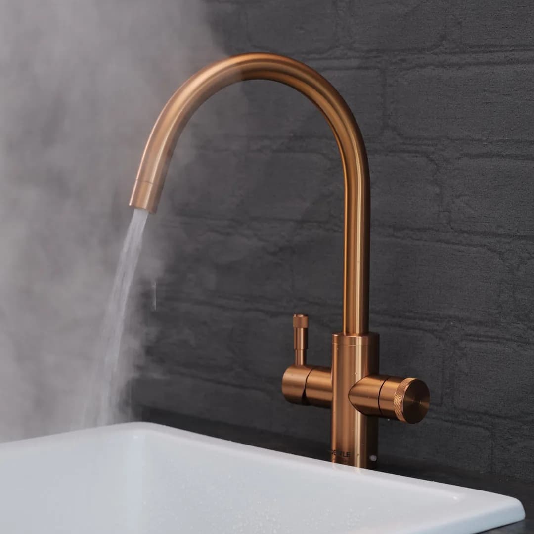 A copper QETTLE tap with steam rising from the spout