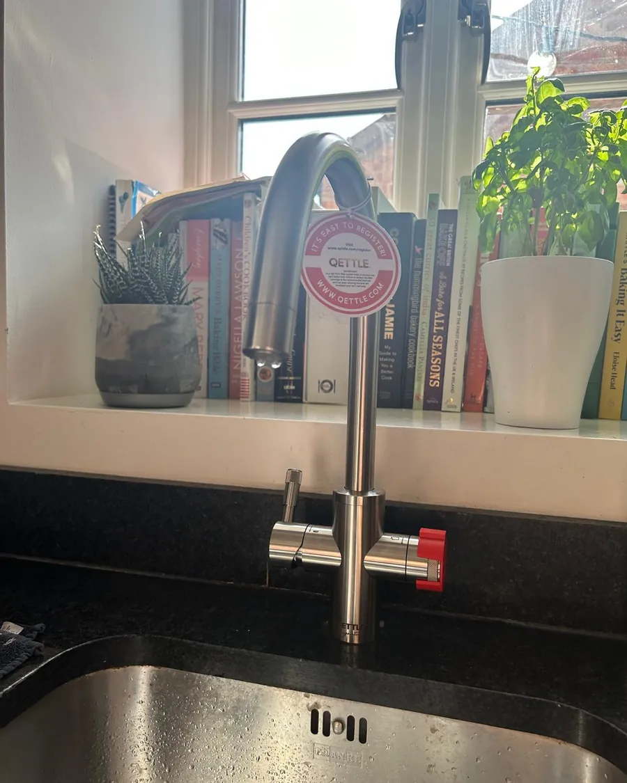 Stainless steel boiling water tap fitted at a kitchen window